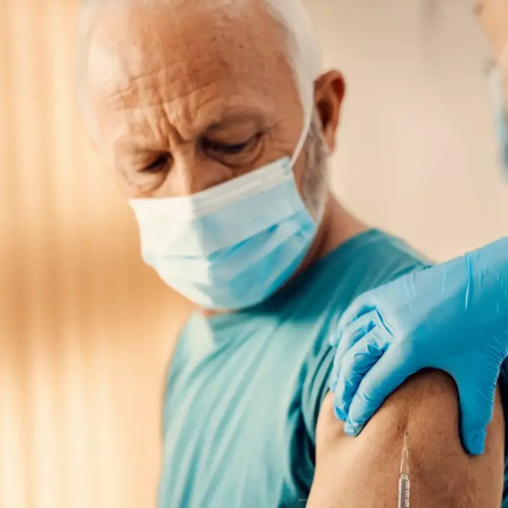 An elderly parent getting the RSV vaccine being administered by a nurse
