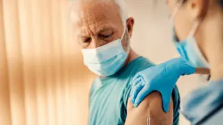 An elderly parent getting the RSV vaccine being administered by a nurse