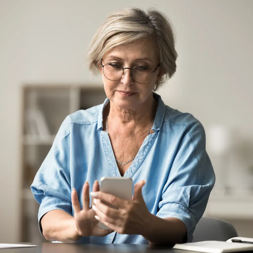 Carent accessing digital support services through her mobile phone
