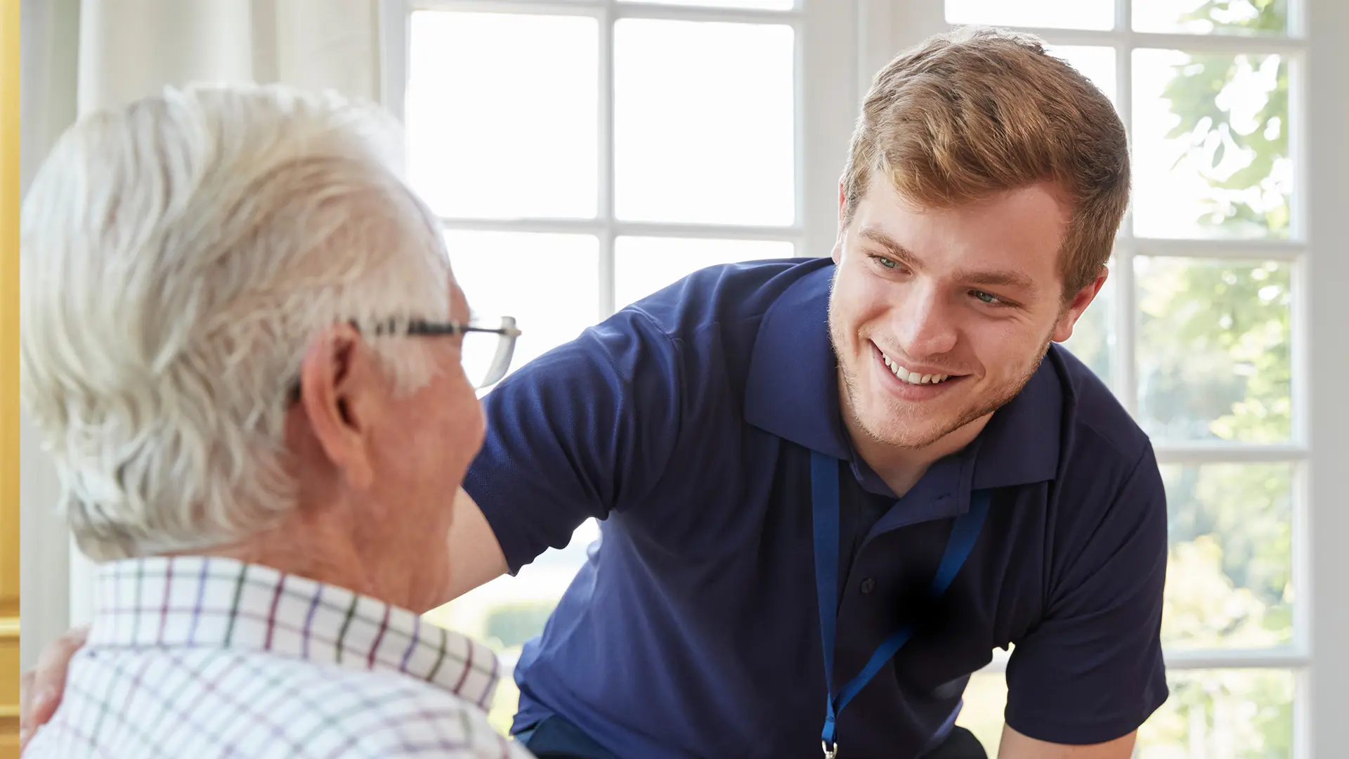 Young carer in a care home looking after an elderly parent 
